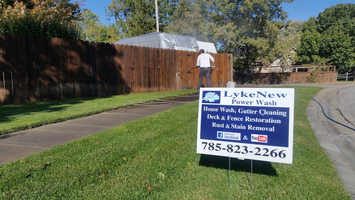 pressure washing a cedar privacy fence at a home in Salina, KS
